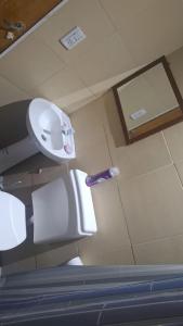 a bathroom with a sink and a toilet at Cande in Parana