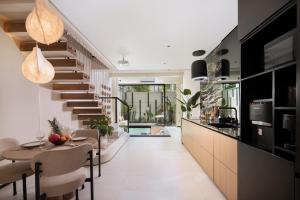 a staircase in a house with a dining room and a kitchen at Echo Beach Villas 6 in Canggu