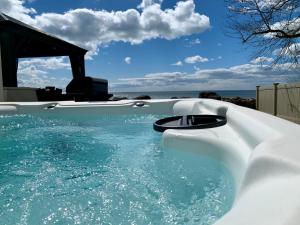 a plunge pool with blue water in a backyard at Casa Azul- Entire Lakefront Cottage with Hot Tub in Leamington