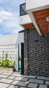 an external view of a building with a brick wall at Sadewa Villa Batu in Punten