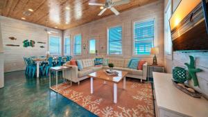 a living room with a couch and a table at Ocean Devotion by AvantStay in Port Aransas