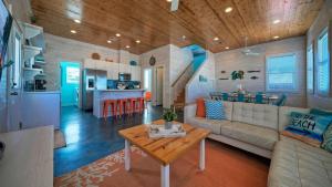 a living room and kitchen with a couch and a table at Ocean Devotion by AvantStay in Port Aransas