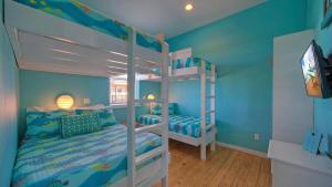 two bunk beds in a room with blue walls at Ocean Devotion by AvantStay in Port Aransas +54 photos