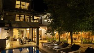 a house with a swimming pool at night at Hiriketiya Beach Resort in Hiriketiya