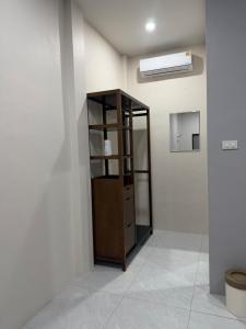 a room with a wooden cabinet in the corner of a room at Third Space House in Ban Nong Chaeng