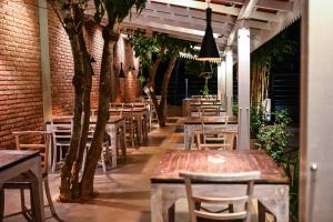 a restaurant with tables and chairs and a brick wall at Hiriketiya Beach Resort in Hiriketiya