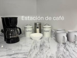 a counter with a coffee maker and cups on it at Casa Morada in Ciudad Juárez +16 photos
