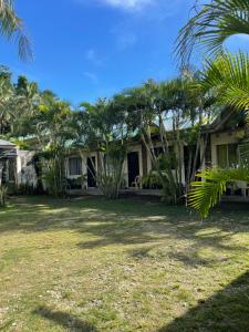 a house with palm trees in front of it at D' Partner's Inn in Jagna