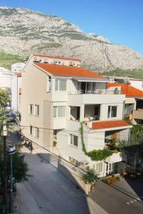 an apartment building with a mountain in the background at House Skrabic in Makarska