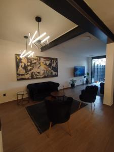 a living room with a couch and a table at Día y noche in Guadalajara +3 photos
