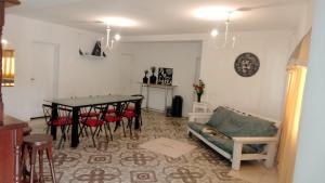 a living room with a table and chairs and a couch at Casa con pileta San Luis Juana Koslay in Juana Koslay 