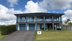 a house with a large driveway in front of it at Diamond Beach Getaway - Diamond Beach in Diamond Beach