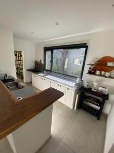 a kitchen with a sink and a large window at La Antonieta in Brandsen