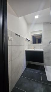 a white bathroom with a sink and a mirror at Modern Hillside Retreat with Panoramic Views in Mussomeli +41 photos
