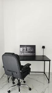 a black desk with a chair and a lamp at Modern Hillside Retreat with Panoramic Views in Mussomeli