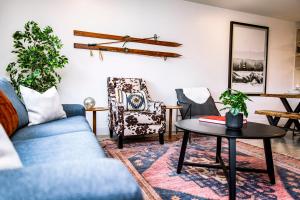 a living room with a blue couch and chairs at Tucker's Place in Revelstoke