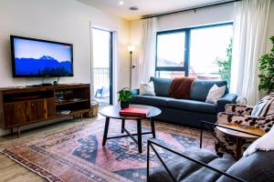 a living room with a couch and a tv at Tucker's Place in Revelstoke