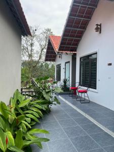 a patio with two chairs and a house at Tam Coc Mountain Light Homestay in Ninh Binh
