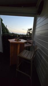 a small table and a chair on a balcony at La Cachette in Le Marin +7 photos