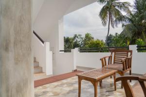 a patio with two chairs and a table on a balcony at Rugee R Villa in Negombo