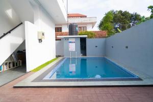 a swimming pool in the backyard of a house at Rugee R Villa in Negombo