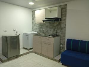 a kitchen with a sink and a stove and a refrigerator at Nápoles city in Medellín