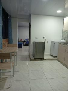 a room with a kitchen with a table and a counter at Nápoles city in Medellín