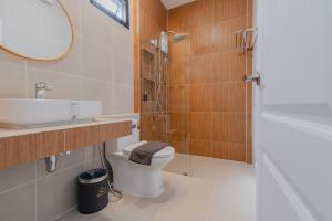 a bathroom with a toilet and a sink and a mirror at เวลการ์เด้น101 in Ban Hua Phrong +31 photos