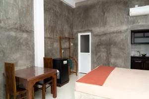 a bedroom with a bed and a desk and a table at Rugee R Villa in Negombo +49 photos