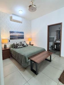 a bedroom with a bed and a bench in it at Salvatierra Home in La Paz +22 photos