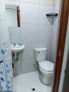 a bathroom with a toilet and a sink at Hospedaje Anny in Larán
