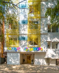 a building with yellow windows and a yellow door at goSTOPS Bengaluru, Indiranagar - Private Rooms & Dorms in Bangalore