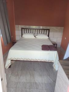 ein Schlafzimmer mit einem großen Bett mit weißer Bettwäsche in der Unterkunft Riverside Inn in El Dorado