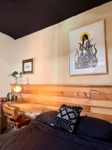 a bedroom with a bed with a wooden head board at 509 Accommodation in Oaxaca City