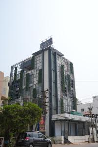 a building with a car parked in front of it at Avenue A boutique hotel in Vijayawāda