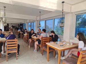 a group of people sitting at tables in a restaurant at Hotel Sonam in Dhulikhel