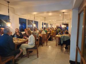 a group of people sitting at tables in a restaurant at Hotel Sonam in Dhulikhel +42 photos