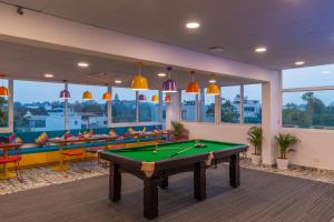 a billiard room with a pool table and chairs at goSTOPS Bengaluru, Indiranagar - Private Rooms & Dorms in Bangalore