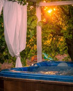 a hot tub in a backyard with a curtain at House With Jacuzzi Among Orchards In Cisternino in Cisternino
