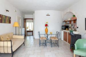 a living room with a couch and a table at House With Jacuzzi Among Orchards In Cisternino in Cisternino