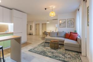 a living room and kitchen with a couch and a table at Central 2BR - Workspace with Elevator in Varna City
