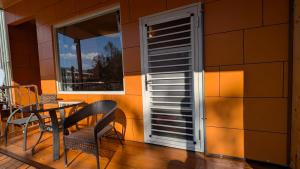 a balcony with a table and chairs and a window at Chingjing ‧ orange Scotia in Ren'ai +52 photos