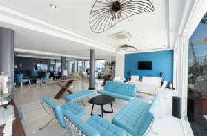 a lobby with blue chairs and a table at Flora Garden BEACH - Couples Concept - Adults over 16 Only in Kızılot