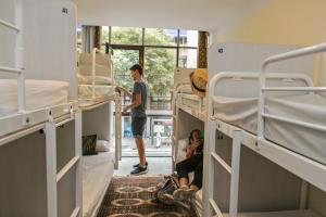 
a man is standing in a room with bunk beds at Pars Tailor's Hostel in Barcelona
