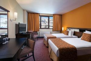 a hotel room with two beds and a flat screen tv at Barida Hotels Davraz in Cobanisa