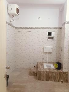 a bathroom with a toilet in the corner of a room at Lotus palm in Deoghar