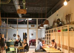 a group of people sitting at tables in a restaurant at Pars Tailor's Hostel in Barcelona