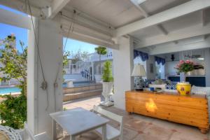 a patio with a table and chairs and a wooden table at Our Hermanus House in Hermanus