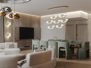 a living room with a table and chairs and a television at Donatello Boutique Hotel in Almaty