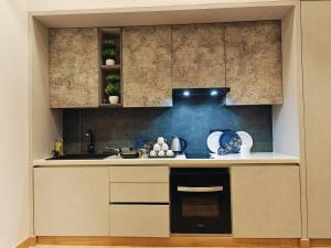 a kitchen with a sink and a stove at KakoonStudios Balcony Bliss in Ghaziabad